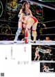 A couple of women wrestling in a wrestling ring.